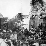 French troopers under General Gouraud driving back Germans with their machine guns amongst the ruins of a cathedral near the Marne